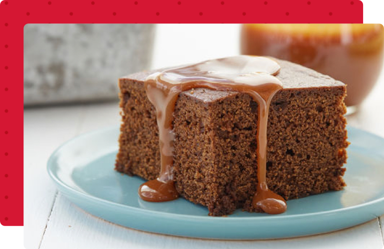 A slice of gingerbread cake on a blue plate