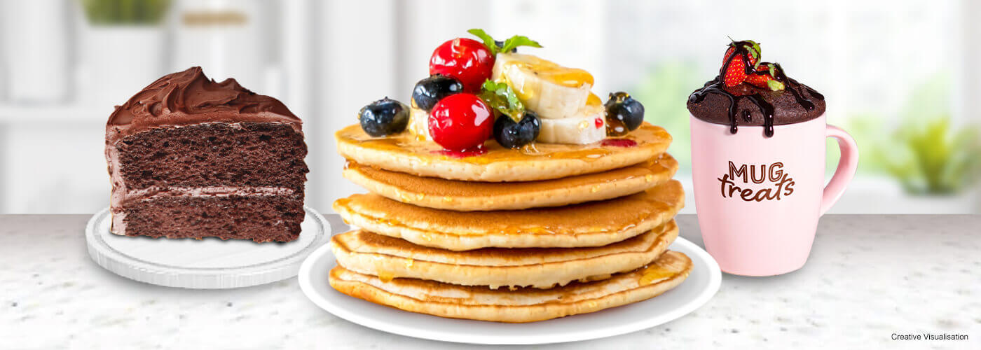 A creative visualization a lifestyle image of a chocolate cake, a stack of pancakes and a pink mug treat on white plates