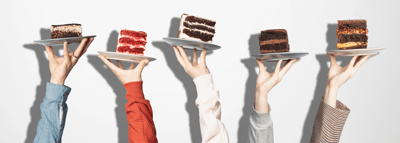 Three slices of cake being held up by three hands. One is chocolate with vanilla frosting, one is chocolate with chocolate frosting and one is strawberry with vanilla frosting