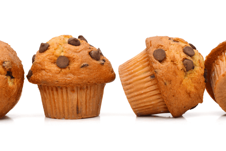 Chocolate cupcakes in a row and one is tilted over