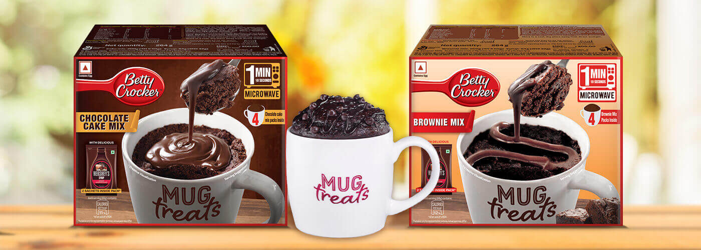 Two mug treat pack shots with a white coffee mug in the middle